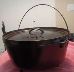 Camping, 14 inch cast iron Dutch oven with lid and l three short legs.