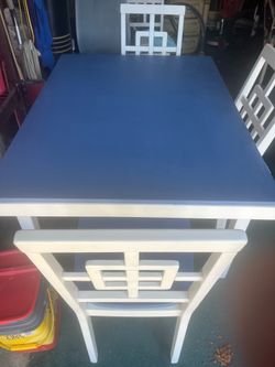Wood dining table . 3x4 with four chairs.