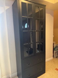 Tall black two door cabinet