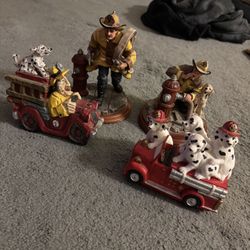 Vintage firefighter and Dalmatian figurines and collectible statues