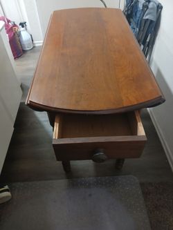 Very nice wood table that folds down on both sides and has drawer