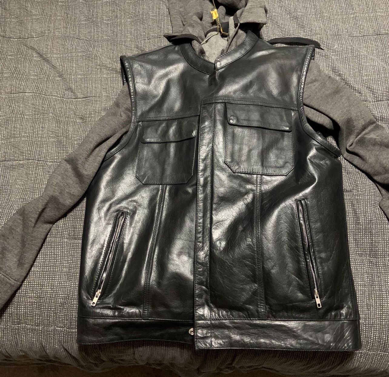 Size Large. Black leather motorcycle vest with concealed gun pockets