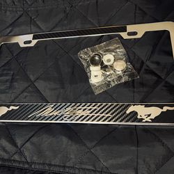 Chrome mustang license plate frame with carbon fiber accents. optional chrome covers to cover screws