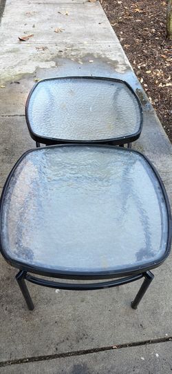 Black metal outdoor side tables featuring square tempered textured-glass tops.