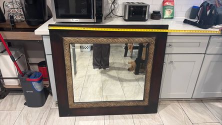 Two large mirrors with metal framing