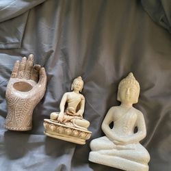 Two Buddha Statues And A Candle Holder 