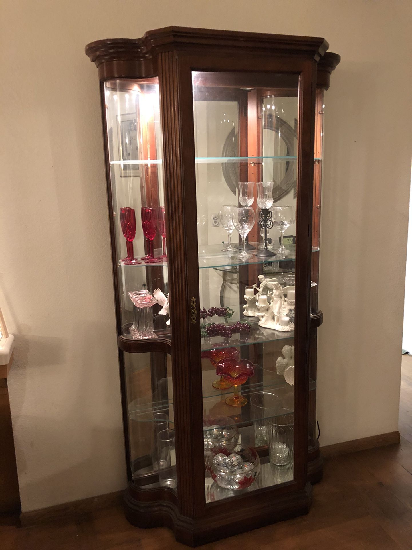 Nice cherry wood curio removable glass shelving mirror background with lighting inside