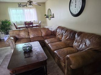 Beautiful leather sectional couch with down cushions.