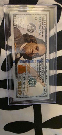 Colorized $100 Federal Reserve Note in a protective holder,