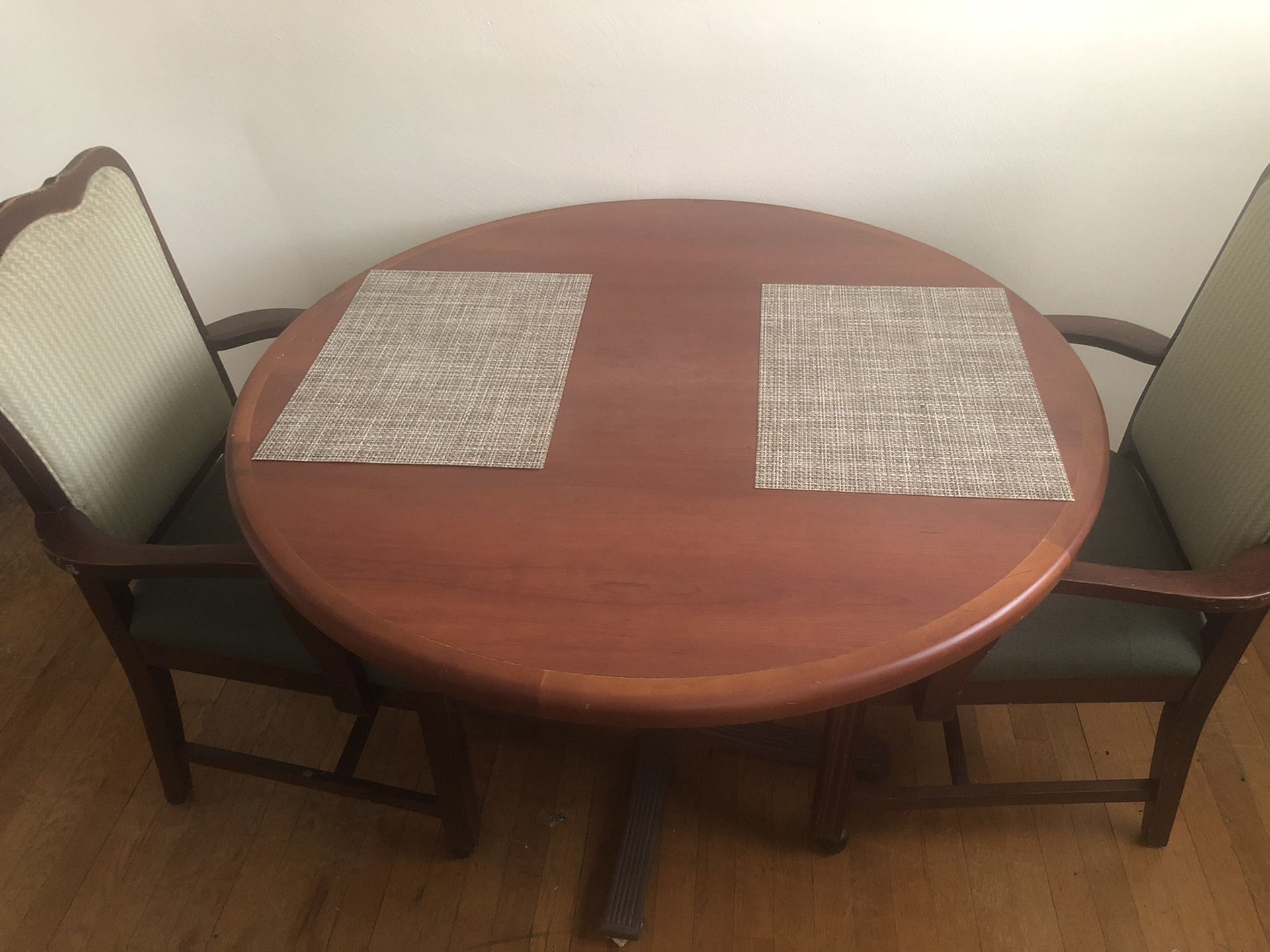 Round dining table with three chairs