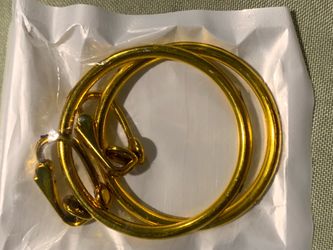 New 2 inch wide plastic gold color clip on hoop earrings.