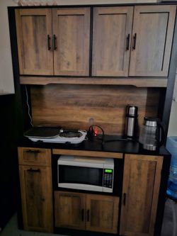 Kitchen pantry storage cabinet with hutch, microwave shelf, and charging station.”