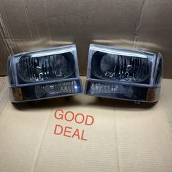 #24 99-04 Ford F250/F350/F450/F550 Super Duty / Excursion Black Halogen Headlight Pair