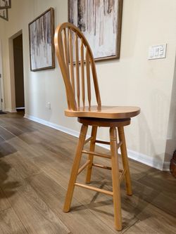 4 hardwood Windsor style counter-height stools that swivel