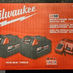 Two Milwaukee 5.0 Batteries And Charger
