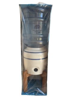 McKesson Water Products countertop water dispenser featuring a white ceramic crock and a top-loading bottle