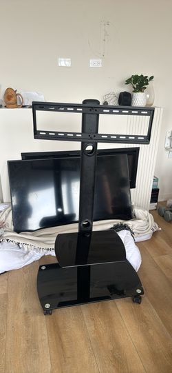 GLASS ROLLING TV STAND HOLDS 50”