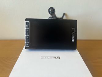 SmallHD 703 Ultrabright. comes with one 2-pin to 2-pin lemo cable, one SDI-BNC cable, one cine arm, and original box.