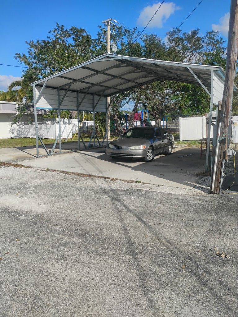 Huge Metal Covered Area I Can Have My Husband Assemble It For You For A Fee. This Can Fit 3 Cars Side By Side Underneath It