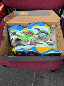 New Balance 9060 sneakers in multi-colored design with pink, green, blue, and yellow accents