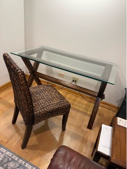 Pottery Barn Ava glass-top desk featuring an espresso-stained solid wood trestle base with distinctive X-shaped legs