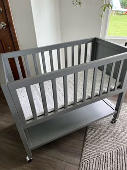 Wooden baby bassinet on wheels