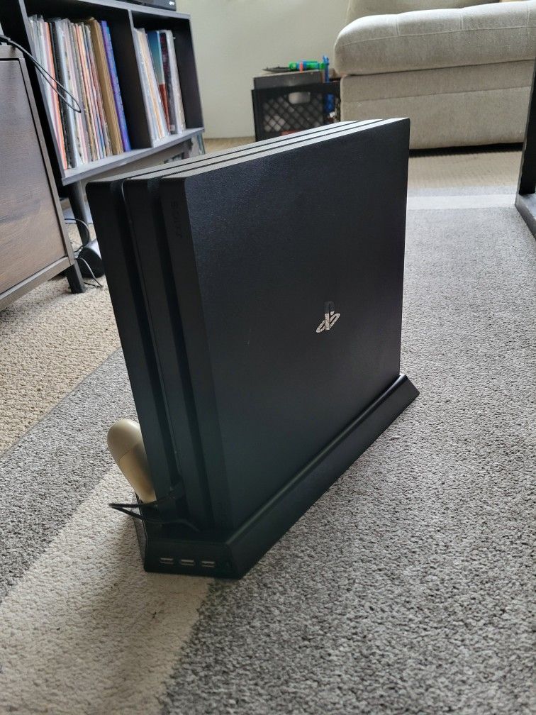 PS4 Pro with controllers and games