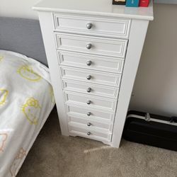 jewelry armoire with drawers, necklace hooks, and ring holders