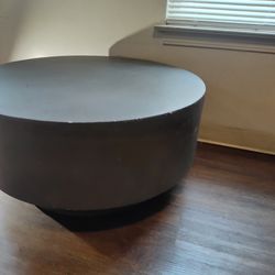 Large round living room coffee table with pedestal bottom