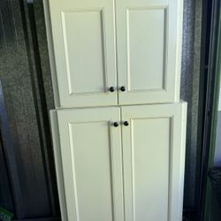 white pantry or storage cabinet.