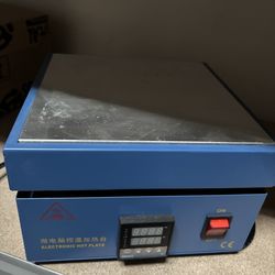 Handy electronic hot plate. Blue color with silver heating surface. Has digital temperature control, simple on/off switch