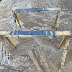 2 metal saw horses 38” wide x 25” tall. They fold compact for easy storage.