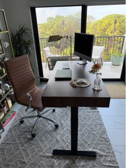 Electric Standing Desk with leather chair and standing light