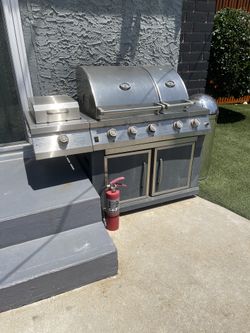 Gas grill with electric start + rotisserie attachment