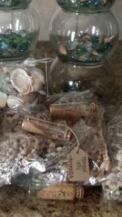 Apothecary mini jars filled with sand and small mini shells