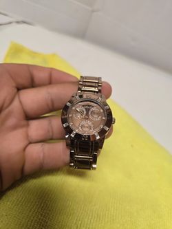 Relic ZR15670 women's watch features a rose-colored dial complemented by a polished gold-tone stainless steel bracelet.
