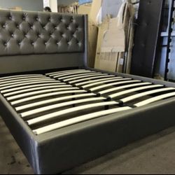 Brand new queen size silver faux leather platform bed frame.