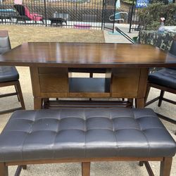 High top table with leather benches and 2 swivel chairs