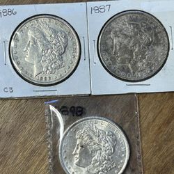 Three Morgan Silver Dollars. Group 25.
