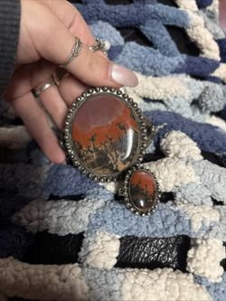 This is a Navajo-made sterling silver cuff bracelet featuring a large petrified wood gemstone