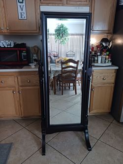 Body mirror jewelry cabinet dark brown color holds all your jewelry with multiple displays for your jewelry.