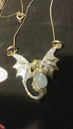 Sparkly Dragon holding a moonstone