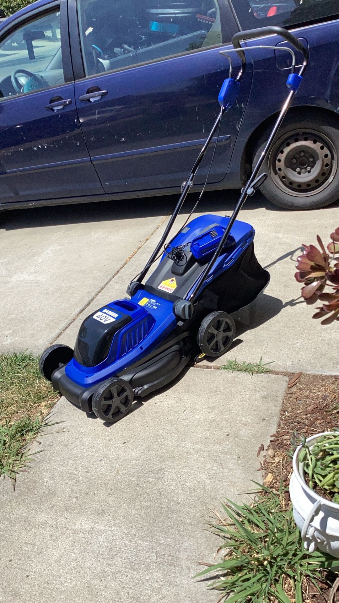 BADGER for the world battery operator lawnmower brand new never been used charger is include