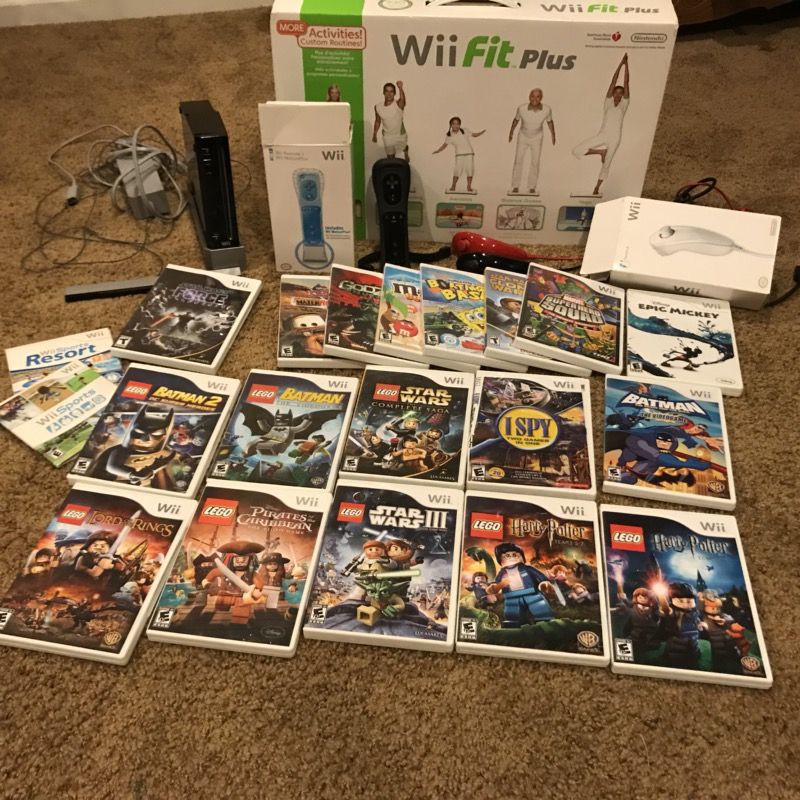 Black Wii with sensor bar, 2 remotes, 2 Wii remote jackets, 3 nunchucks, and includes 20 Wii games