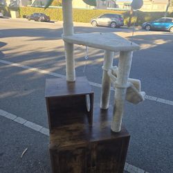 Cat Tree With Plant And A Littet Cabinet