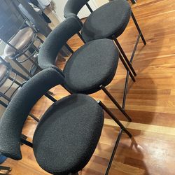 3 black cushioned chairs 23”in tall in good condition