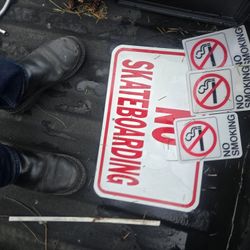No Smoking And No Skateboarding Signs 