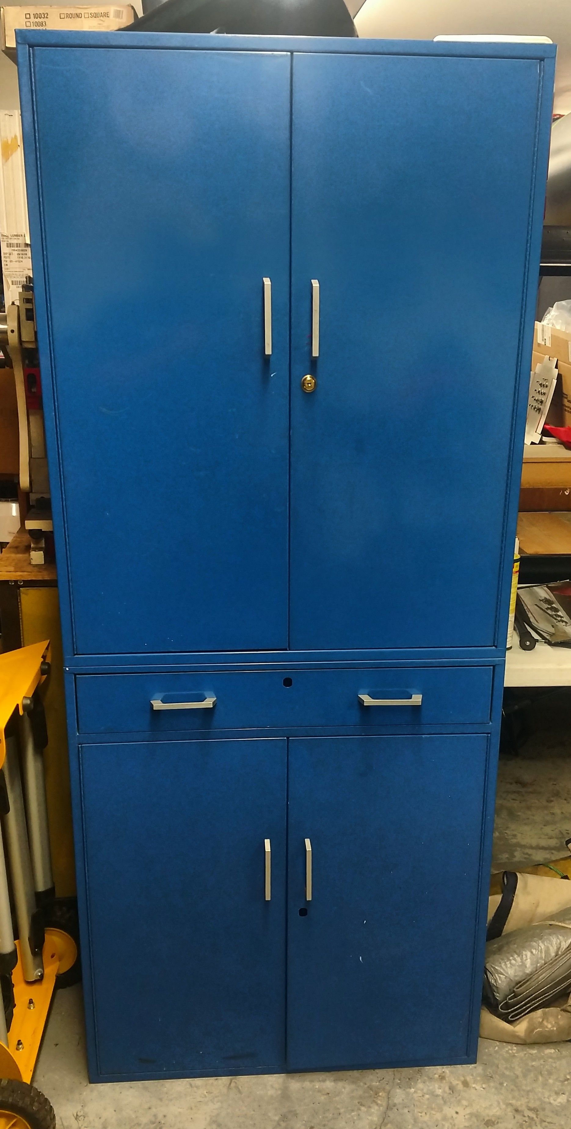 Tall metal cabinet with drawer