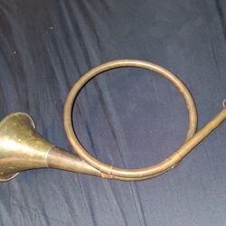Round brass hunting horn