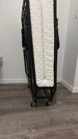 Folding bed with mattress